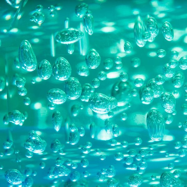 A woman feeling energetic and vibrant with abstract cyan light trails around her.